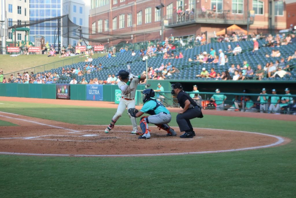 Greensboro Grasshoppers infielder Yoyner Fajardo warms up before his first at-bat of the game against the Asheville Tourists. Fajardo has been with the Grasshoppers since August of 2021.