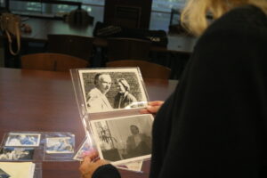 Over the shoulder shot of a woman looking at a black and white photo graph.